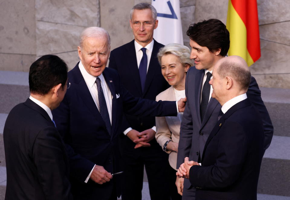 U.S. President Joe Biden speaks with Japan's Prime Minister Fumio Kishida, Germany's Chancellor Olaf Scholz, Canada's Prime Minister Justin Trudeau, European Commission President Ursula von der Leyen and NATO Secretary General Jens Stoltenberg before a G7 leaders' family photo during a NATO summit on Russia's invasion of Ukraine, at the alliance's headquarters in Brussels, Belgium March 24, 2022. REUTERS/Henry Nicholls/Pool