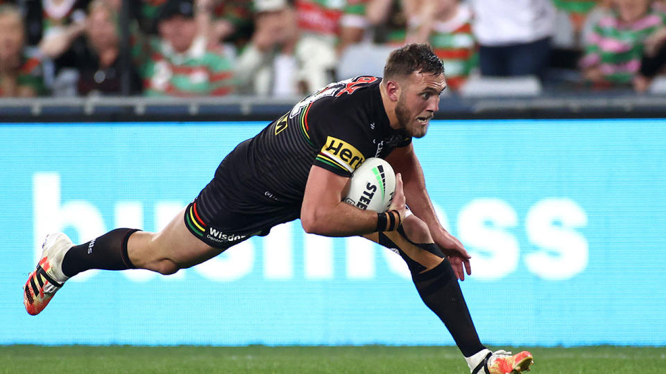 Pictured here, Kurt Capewell dives over for a try for the Penrith Panthers in the NRL.