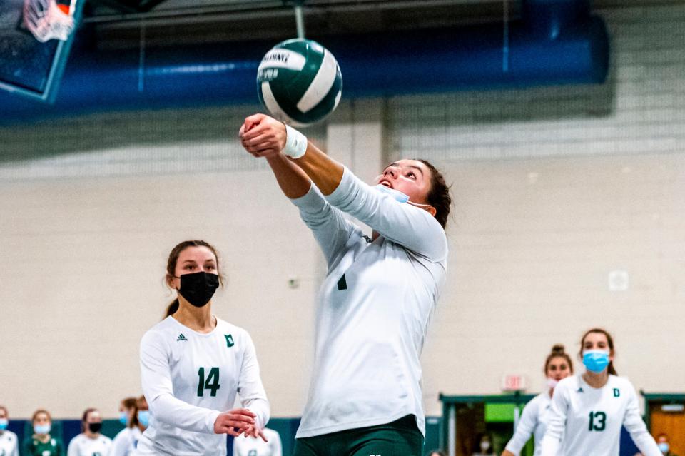 Dartmouth's Lauren Augusto hits the over the shoulder shot to keep the ball in play.