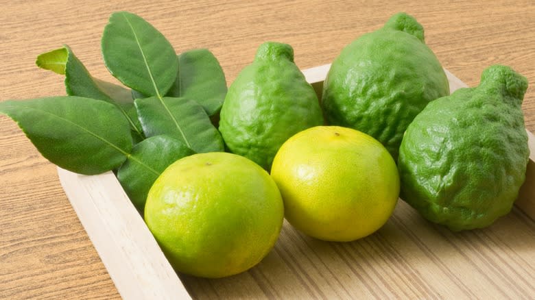 Different limes on wooden background 