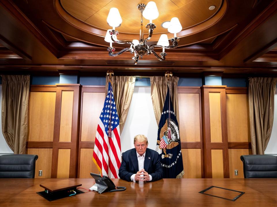 In this handout provided by the White House, then-President Donald Trump participates in a phone call with Vice President Mike Pence, Secretary of State Mike Pompeo, and Chairman of the Joint Chiefs of Staff Gen. Mark Milley in his conference room at Walter Reed National Military Medical Center on October 4, 2020 in Bethesda, Maryland. Chief of Staff Mark Meadows is also present in the room on the call.
