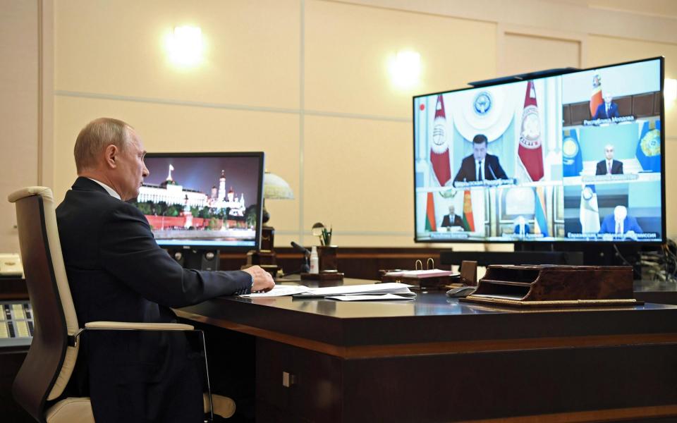 Vladimir Putin takes part in a video conference meeting - Getty Images