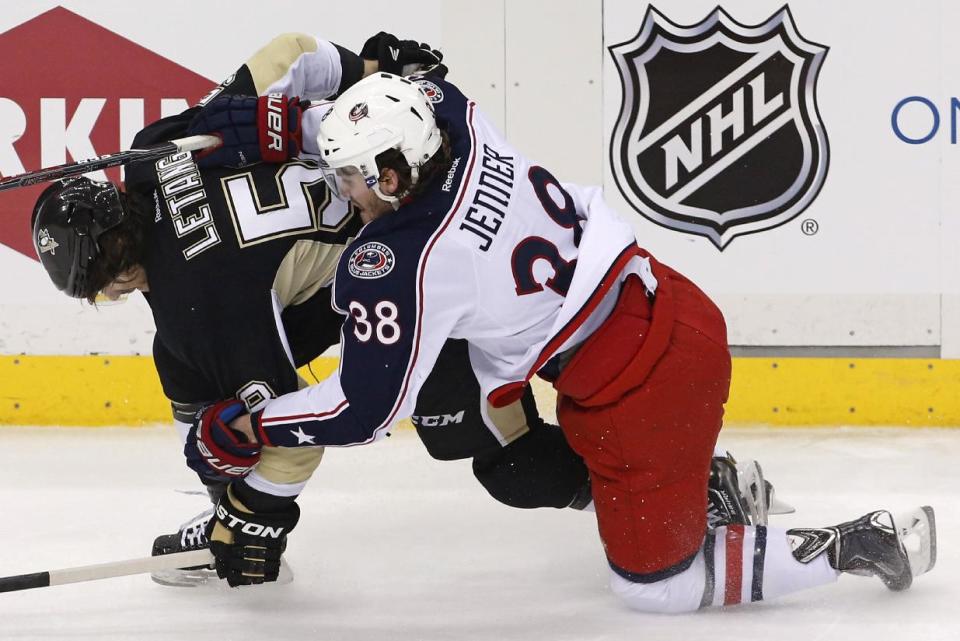 Columbus Blue Jackets' Boone Jenner (38) collides with Pittsburgh Penguins' Kris Letang (58) in the first period of Game 5 of a first-round NHL playoff hockey series in Pittsburgh Saturday, April 26, 2014. (AP Photo/Gene J. Puskar)