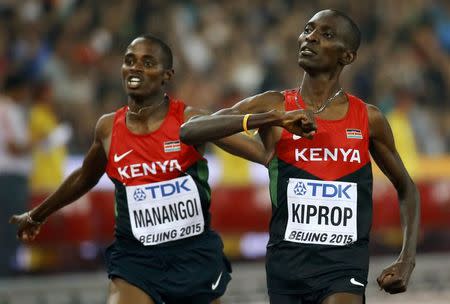 Kenya's Asbel Kiprop (R) celebrates as he crosses the finish line to win the men's 1500 metres final during the 15th IAAF World Championships at the National Stadium in Beijing, China August 30, 2015. REUTERS/Damir Sagolj