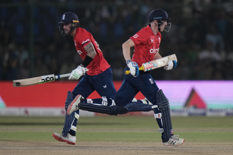 England's Harry Brook, right, and Alex Hales run between the wickets to score during the first T20 cricket match between Pakistan and England, in Karachi, Pakistan, Tuesday, Sept. 20, 2022. (AP Photo/Anjum Naveed)