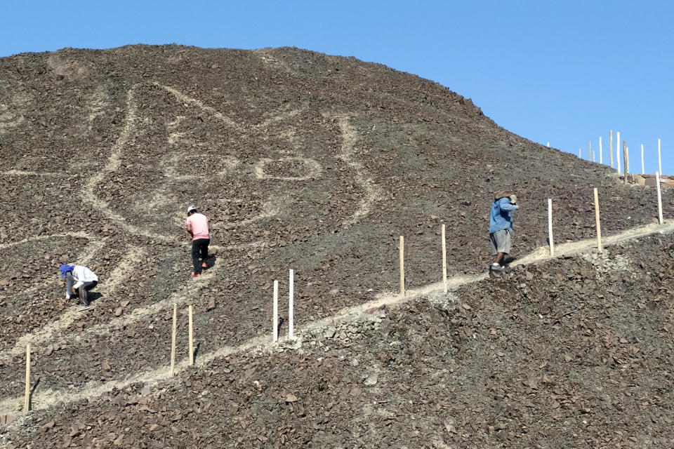 This handout photo provided by Peru's Ministry of Culture-Nasca-Palpa shows the figure of a feline on a hillside in Nazca, Peru, Friday,  / Credit: Jhony Islas / AP