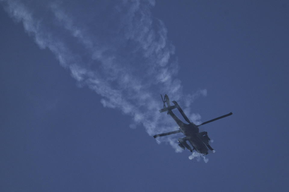 An Israeli Apache helicopter fires in the direction of the Gaza Strip as seen from southern Israel, Tuesday, Jan. 23, 2024. (AP Photo/Leo Correa)