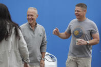 NASA astronauts Douglas Hurley, left, and Robert Behnken smile outside the Neil A. Armstrong Operations and Checkout Building, at the Kennedy Space Center in Cape Canaveral, Fla., Wednesday, May 27, 2020. The two astronauts will fly on a SpaceX test flight to the International Space Station. For the first time in nearly a decade, astronauts will blast into orbit aboard an American rocket from American soil, a first for a private company. (AP Photo/John Raoux)