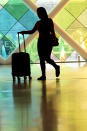 A traveler walks through Miami International Airport, Wednesday, July 3, 2024, in Miami. A long Fourth of July holiday weekend is expected to create new travel records. (AP Photo/Lynne Sladky)