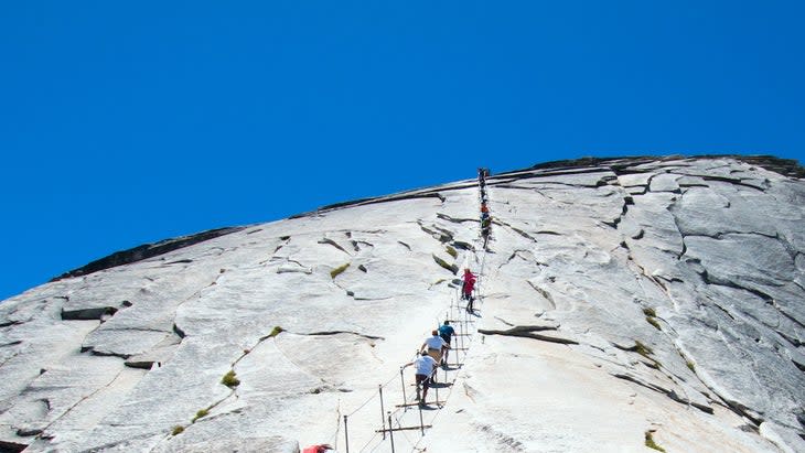 Cables with climbers on Half Dome in Yosemite National Park in California United States