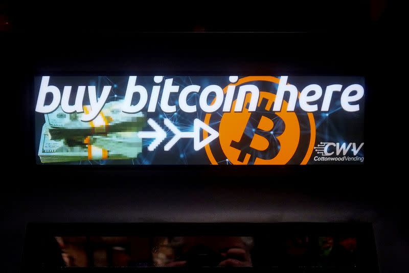 FILE PHOTO: A Bitcoin ATM sign is pictured in a bodega in New York