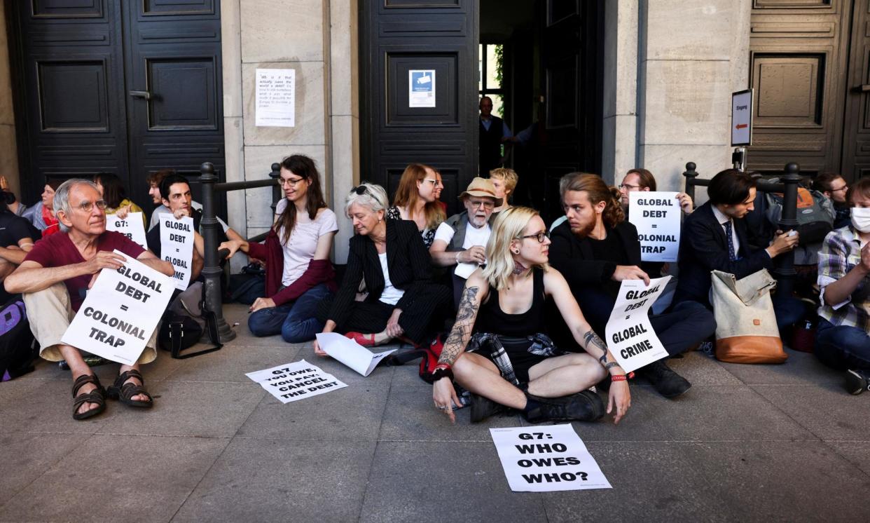 <span>Debt justice activists block the German finance ministry during the 2022 G7 summit in Berlin.</span><span>Photograph: Christian Mang/Reuters</span>