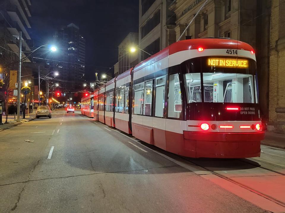 Toronto Transit Commission streetcars sit on Adelaide street east at night on Tuesday Jan. 31, 2023. The TTC will resume issuing tickets for fare evasion at the end of March. They stopped ticketing riders who didn't pay to use the system during the early days of the pandemic.