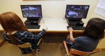 Claire Hofstra, left, and Kaila Morris play "Heroes of the Storm," at Hathaway Brown School, Wednesday, July 10, 2019, in Shaker Heights, Ohio. Hathaway Brown launched the country's first varsity esports program at an all-girls school. Coach J Collins hopes to encourage more girls to stick with video games through their teenage years, something that might have a ripple effect across an industry grappling with gender disparity. (AP Photo/Tony Dejak)