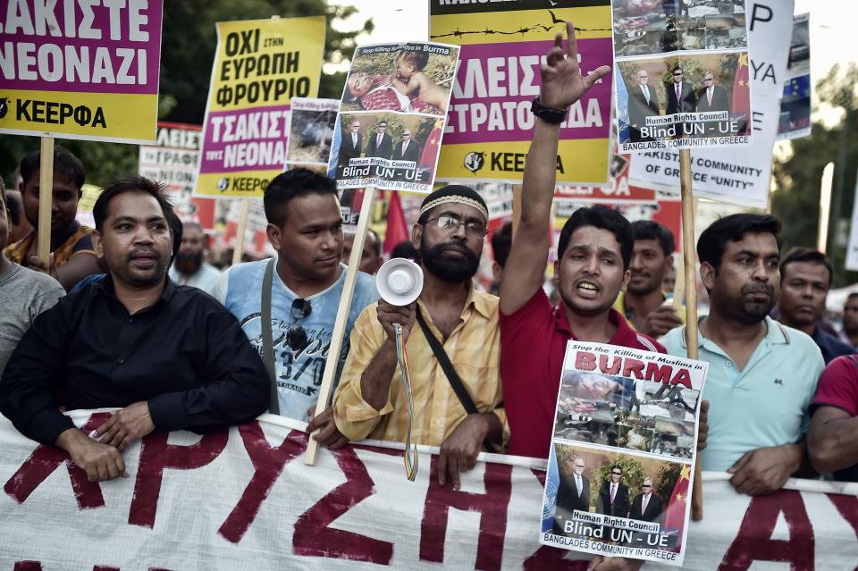 <p>Bangladeshi and Pakistani migrants to Greece along with Greek protesters hold banners against the killing of the Rohingya people in Myanmar as they participate in an anti fascism demonstration in Athens on Sept. 16, 2017. Hundreds of people joined an anti-racism protest in Athens held to commemorate the shock murder of an anti-fascist rapper in 2013 by a member of the neo-Nazi party Golden Dawn. (Photo: Louisa Gouliamaki/AFP/Getty Images) </p>