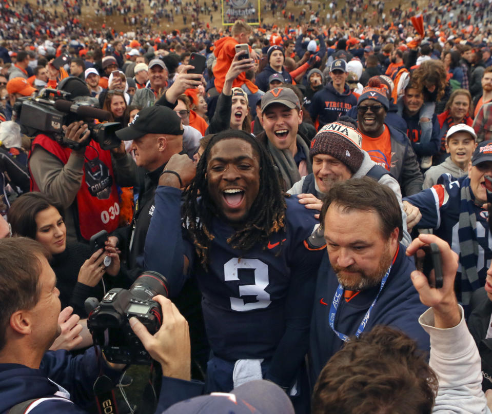 Virginia quarterback Bryce Perkins (3) celebrates with fans after their 39-30 win over Virginia Tech in an NCAA college football game Friday, Nov. 29, 2019, in Charlottesville Va. (Matt Gentry/The Roanoke Times via AP)