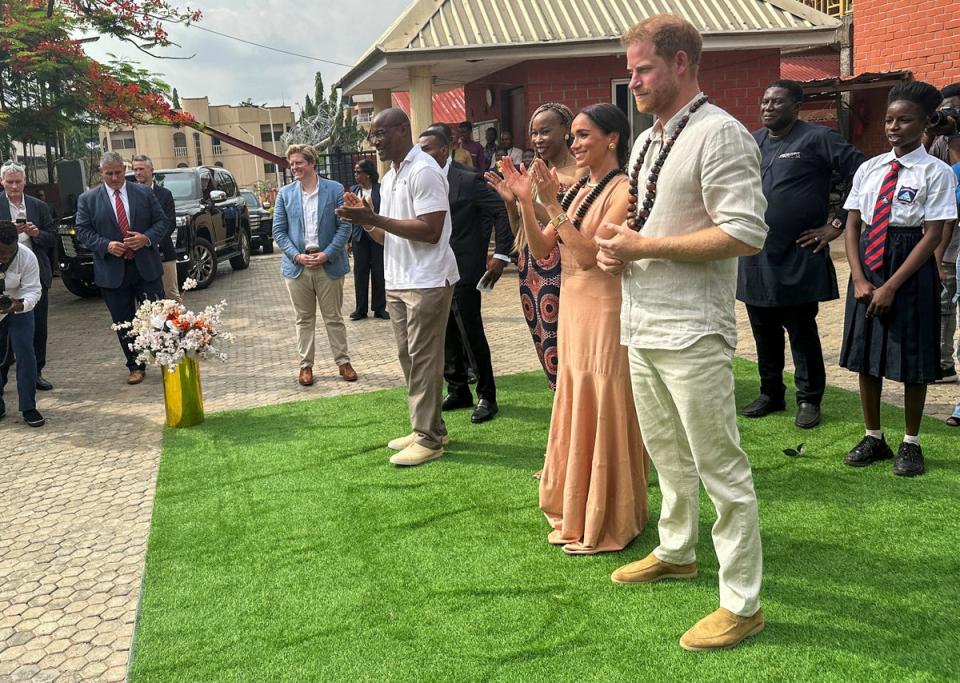 Meghan and Harry meet students at the Lightway Academy up on their arrival in Abuja, Nigeria (REUTERS)