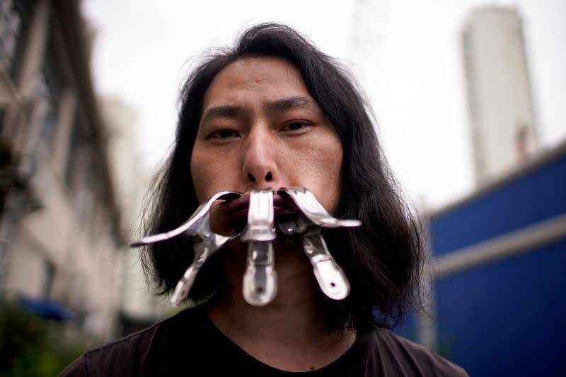 Brother Nut, Chinese performance artist, poses for a picture in Shanghai