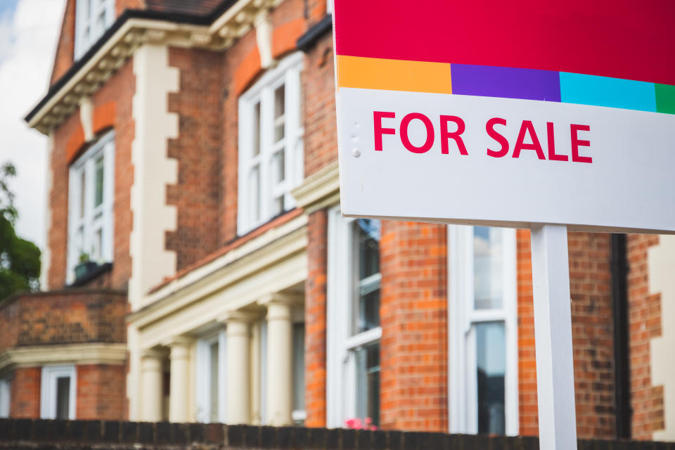 For Sale estate agent sign displayed outside a terraced house in Crouch End, London