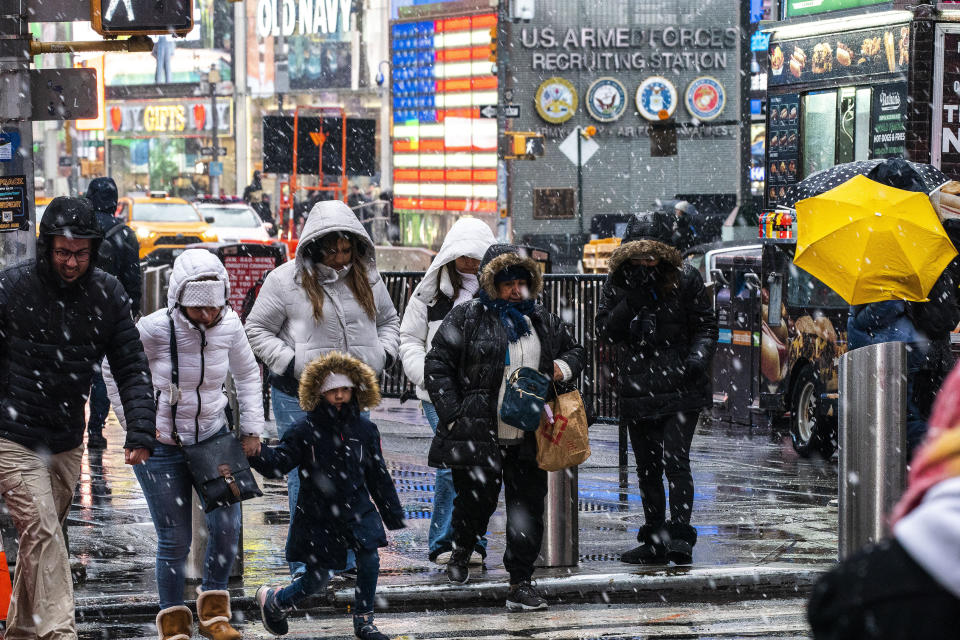 People walk around Times Square during a winter storm in New York, Sunday, Jan. 7, 2024. (AP Photo/Eduardo Munoz Alvarez)