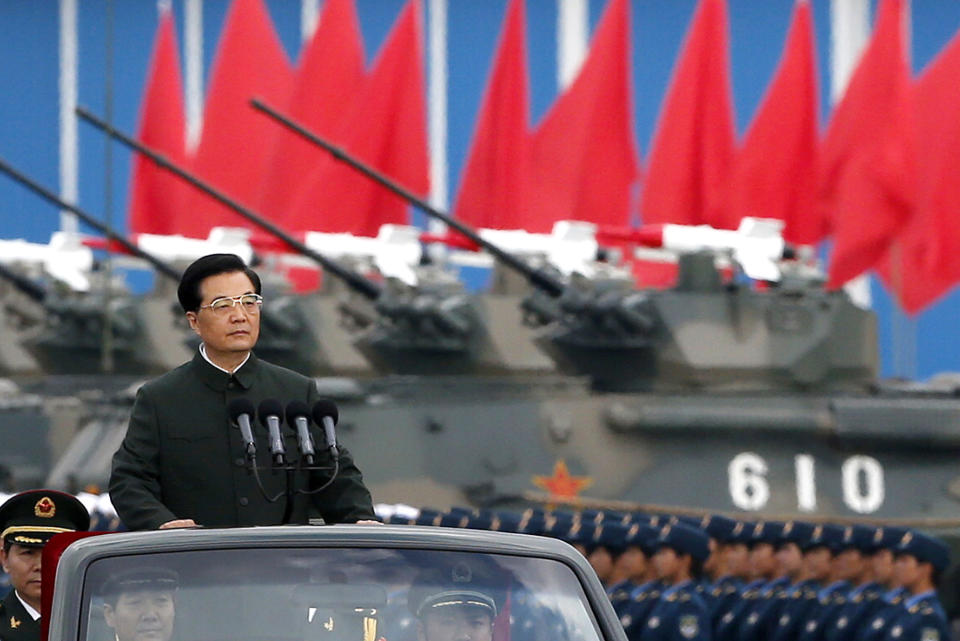 FILE - In this June 29, 2012 file photo, Chinese President Hu Jintao inspects People's Liberation Army soldiers at a camp in Hong Kong. As Hu steps down as head of China’s Communist Party after 10 years in power, he’s hearing something unusual for a Chinese leader: sharp criticism. (AP Photo/Vincent Yu, File)