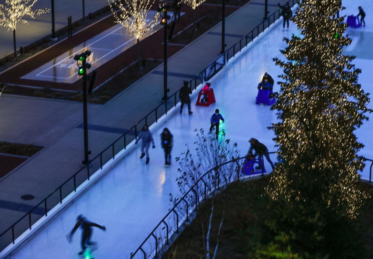 Family and friends gather on Wednesday, Nov. 18, 2020, at Titletown's Ice Skating Rink in Ashwaubenon, Wis.