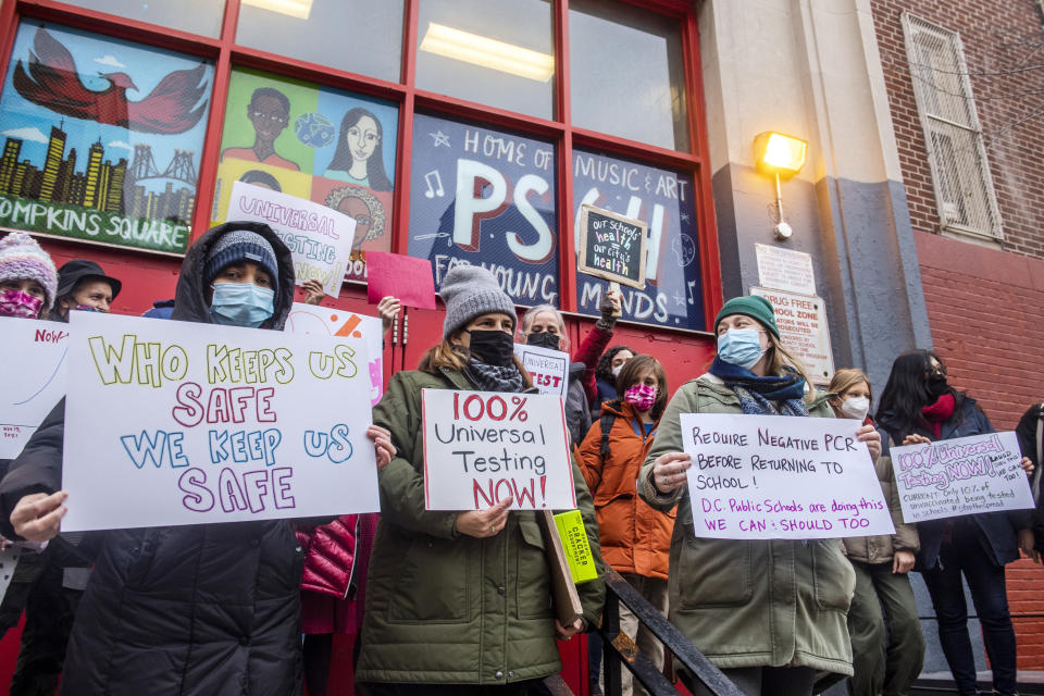 Teachers from the Earth School speak out on issues related to lack of COVID testing outside of P.S. 64 on Tuesday, Dec. 21, 2021, in New York. (AP Photo/Brittainy Newman)