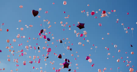 People release balloons as they take part in a vigil for the victims of an attack on concert goers at Manchester Arena, in Royton, near Manchester, Britain May 26, 2017. REUTERS/Phil Noble