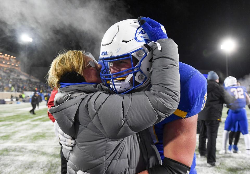 South Dakota State’s Mason McCormick receives a celebratory hug from a loved one after the team beat Montana State in the FCS semifinals, sending them to the national championship, on Saturday, December 17, 2022, at Dana J. Dykhouse Stadium in Brookings, SD.