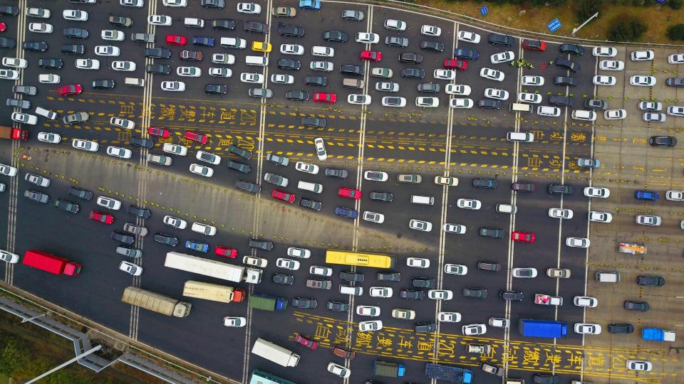 Aerial view of vehicles waiting to pass a toll station on the Shenyang-Haikou expressway before the upcoming Chinese Spring Festival holiday in 2018.