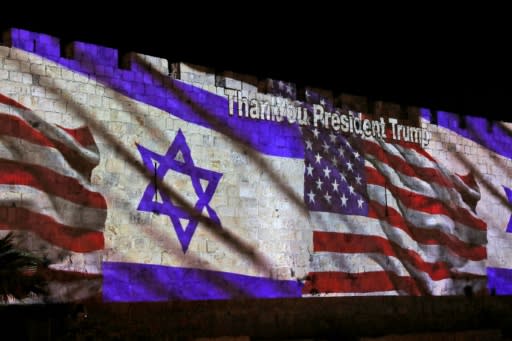 The Israeli and United States flags are projected on the walls of the ramparts of Jerusalem's Old City, to mark the opening of the new US embassy on May 14, 2018