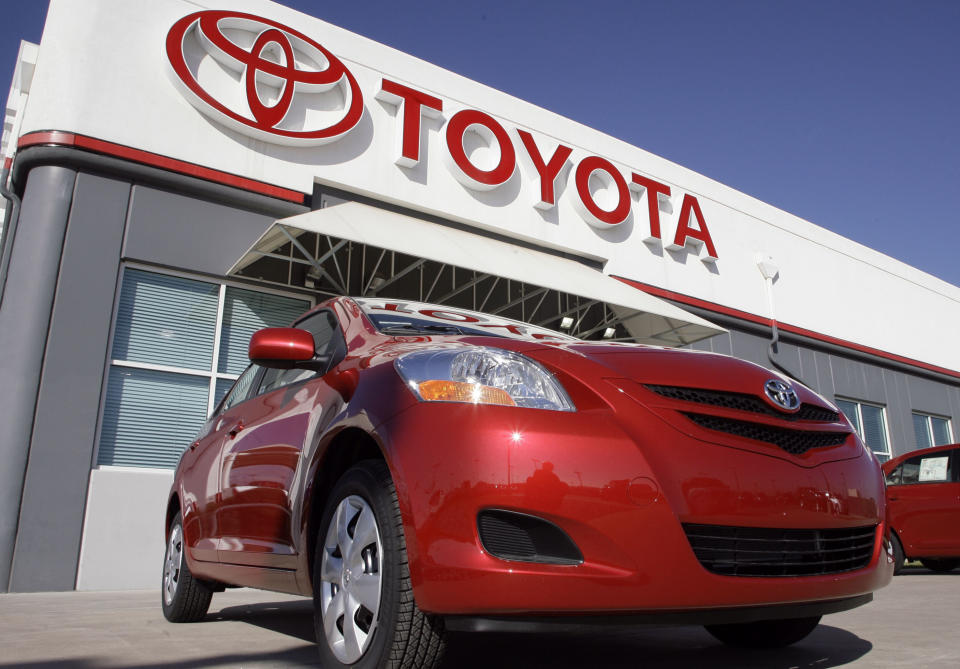 FILE - in this Oct. 22, 2006 file photo, the Toyota sign hangs over a 2007 Yaris sedan on sale on the lot of a Toyota dealership in the southeast Denver suburb of Centennial, Colo. Toyota Motor Corp. is recalling 7.43 million vehicles in the U.S., Japan, Europe and elsewhere around the world for a faulty power-window switch ó the latest, massive quality woes for Japan's top automaker. The recall, announced Wednesday, Oct. 10, 2012 affects more than a dozen models produced from 2005 through 2010. (AP Photo/David Zalubowski, File)