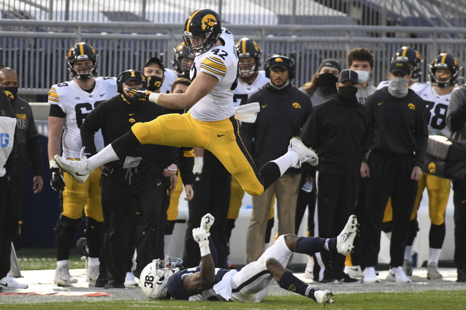 Iowa tight end Shaun Beyer (42) hurdles Penn State safety Lamont Wade (38) in the first quarter of an NCAA college football game in State College, Pa., on Saturday, Nov. 21, 2020. (AP Photo/Barry Reeger)