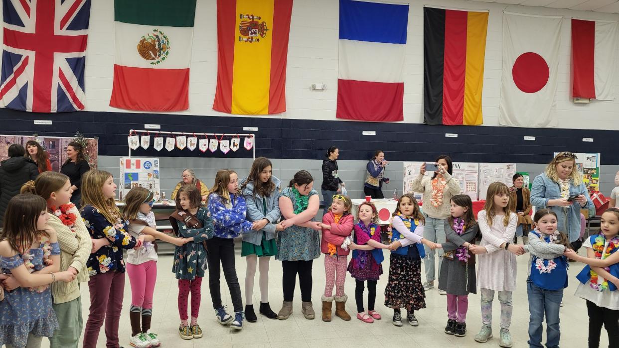 Granville Girl Scouts make a friendship circle during a March 19 event celebrating Girl Scouts 's 111th birthday. During the event, called "Friendships Circle the World," girls sampled foods and participated in activities from around the globe.