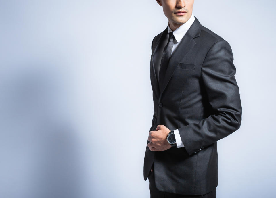 A man posing in a suit.