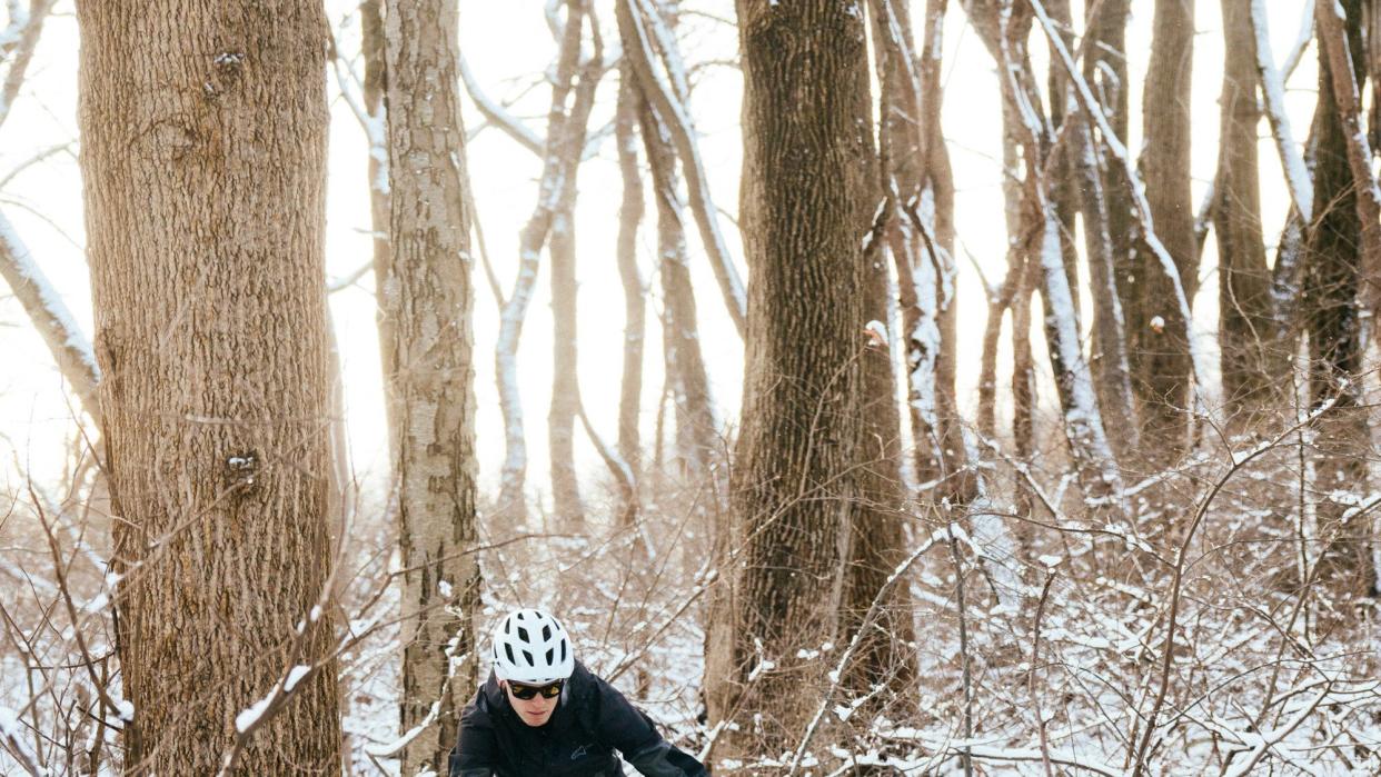 a person riding a bike through the snow