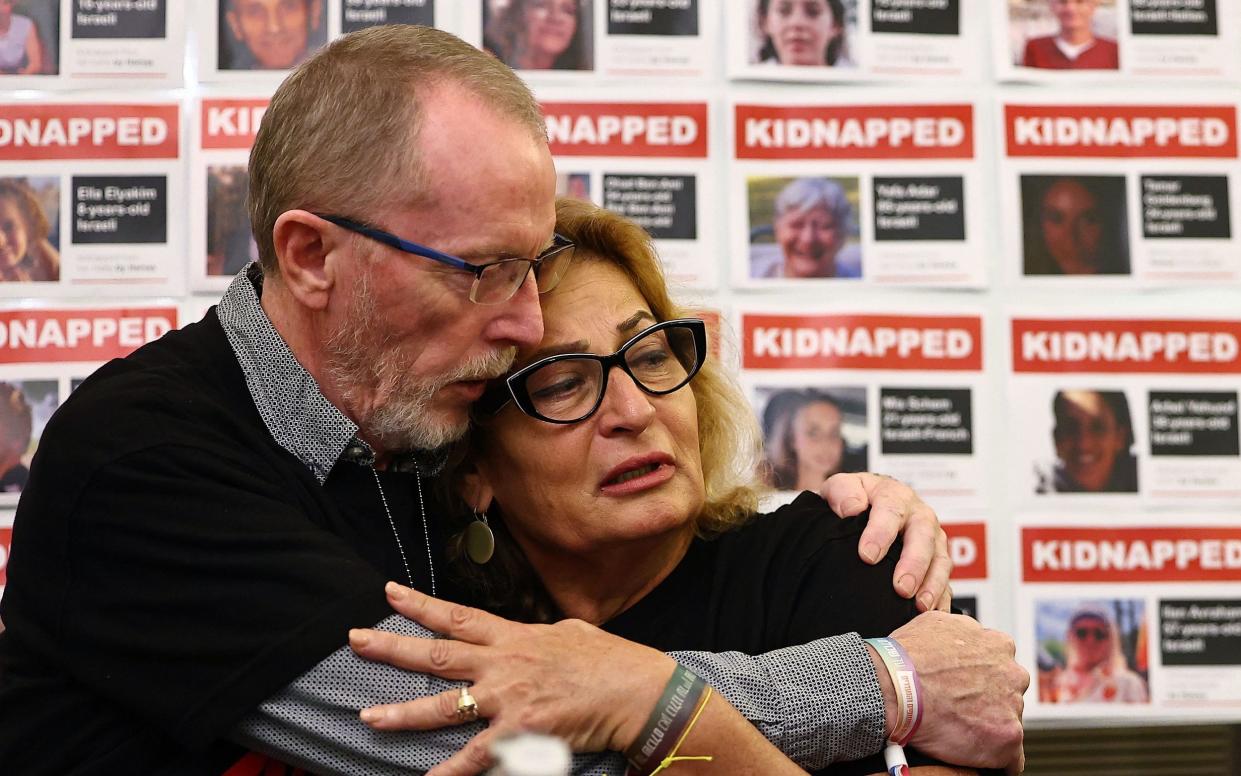 Orit Meir (R), mother of Almog Meir, hugs Thomas Hand, father of Emily Hand, during a press conference by families of hostages held by Palestinian militant group Hamas in Gaza