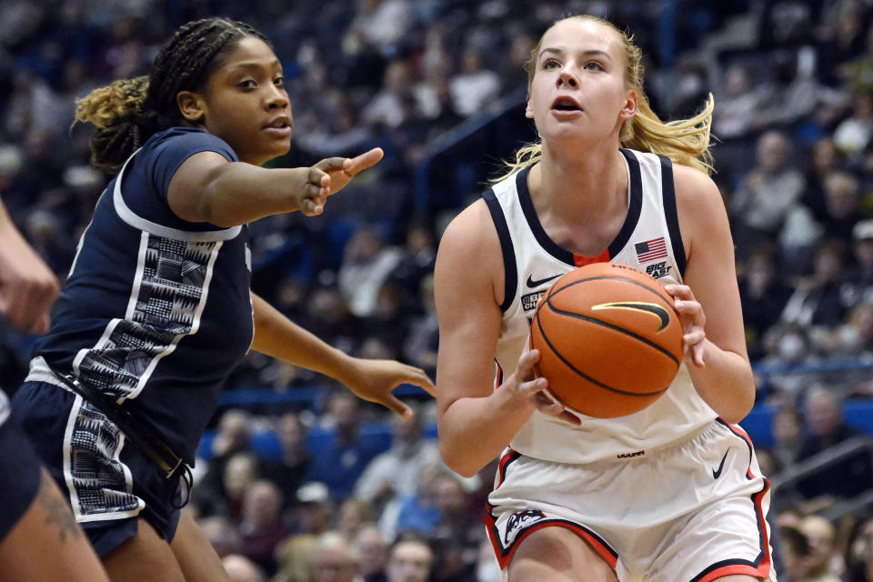 UConn's Dorka Juhasz, right, looks to shoot as Georgetown's Ariel Jenkins, left, defends in the first half of an NCAA college basketball game, Sunday, Jan. 15, 2023, in Hartford, Conn. (AP Photo/Jessica Hill)