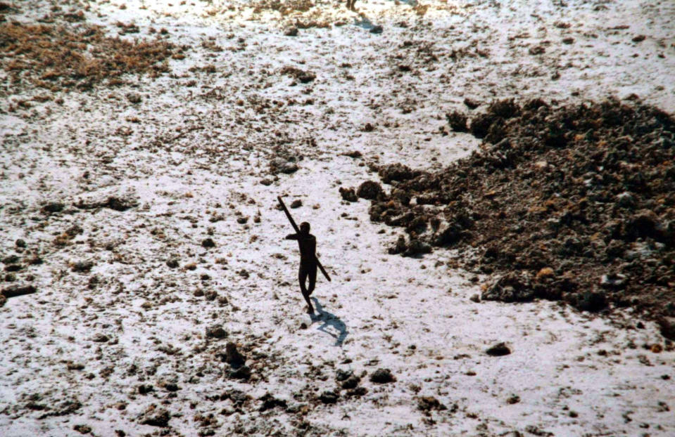 Image: A Sentinel tribal man aims with his bow and arrow at an Indian Coast Guard helicopter as it flies over their island for survey in India's Andaman and Nicobar archipelago. (Indian Coast Guard / AP file)