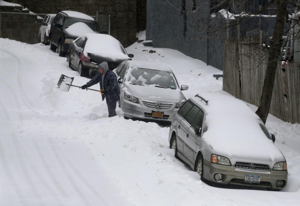 A man digs his car out along William Street during a snow storm, Tuesday, March 14, 2017, in New York. New York Gov. Andrew Cuomo has declared a state of emergency Tuesday for all of New York's 62 counties, including New York City's five boroughs. (AP Photo/Julie Jacobson)