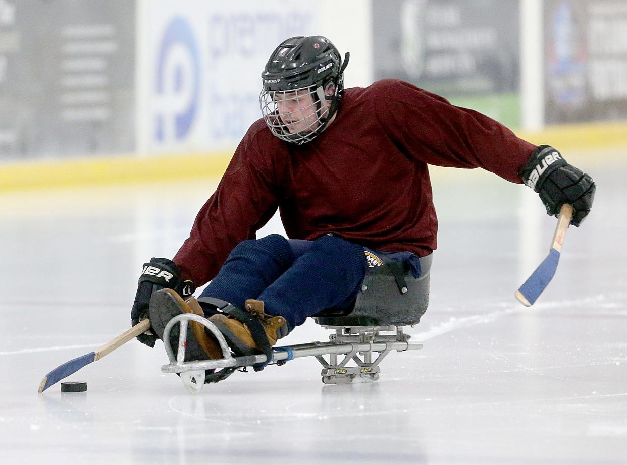 Canton Tuskies player Patrick Brennan looks to pass the puck during a practice at the Center Ice Sports Complex on Monday, Feb. 19, 2024.