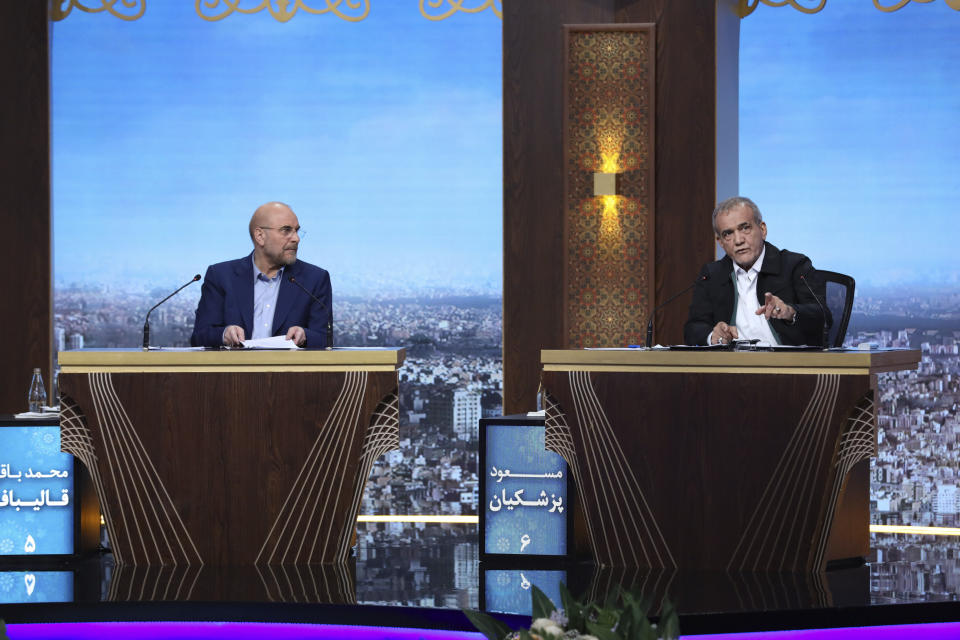 FILE - In this picture made available by Iranian state-run TV, IRIB, reformist presidential candidate for the June 28 election Masoud Pezeshkian, right, speaks as another candidate Mohammad Bagher Qalibaf, listen to him in a debate of the candidates at the TV studio in Tehran, Iran, June 25, 2024. Even in a busy year of elections, the next few days stand out. Voters go to the polls over the next week in fledgling democracies like Mauritania and Mongolia, in the Islamic Republic of Iran and in the stalwart democracies of Britain and France. (Morteza Fakhri Nezhad/IRIB via AP, File)