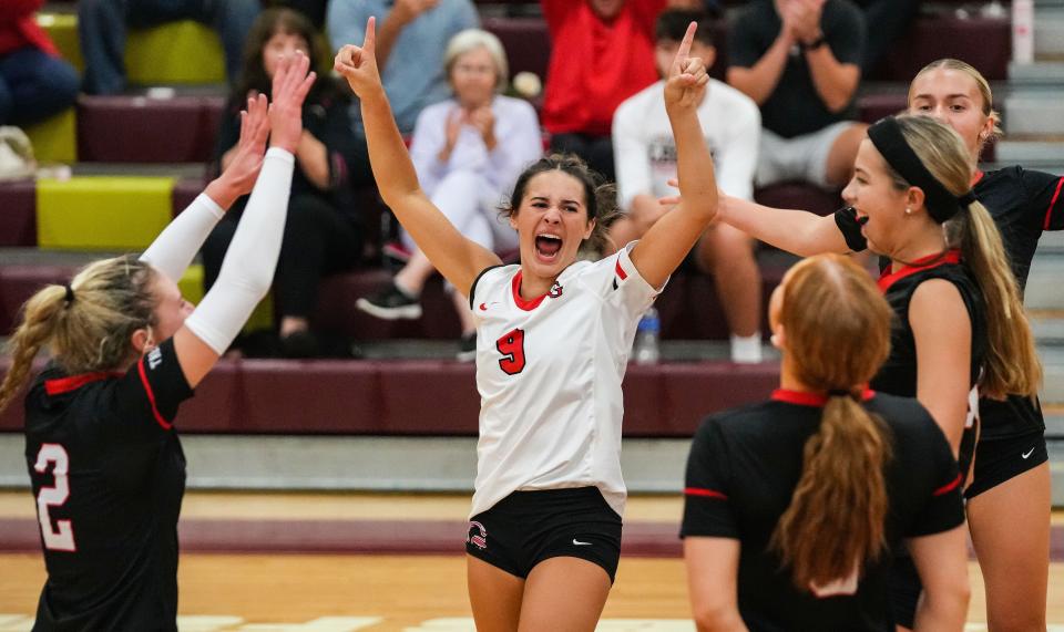 Center Grove Trojans yell in excitement after a point Thursday, Sept. 14, 2023, during the game against Brebeuf Jesuit at Brebeuf Jesuit Preparatory School in Indianapolis. The Center Grove Trojans defeated Brebeuf Jesuit, 3-2.