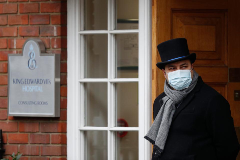 A doorman looks out from the entrance to King Edward VII hospital in central London on February 22, 2021 where Britain's Prince Philip, Duke of Edinburgh remains after being admitted on February 16. (Photo by Adrian DENNIS / AFP) (Photo by ADRIAN DENNIS/AFP via Getty Images)