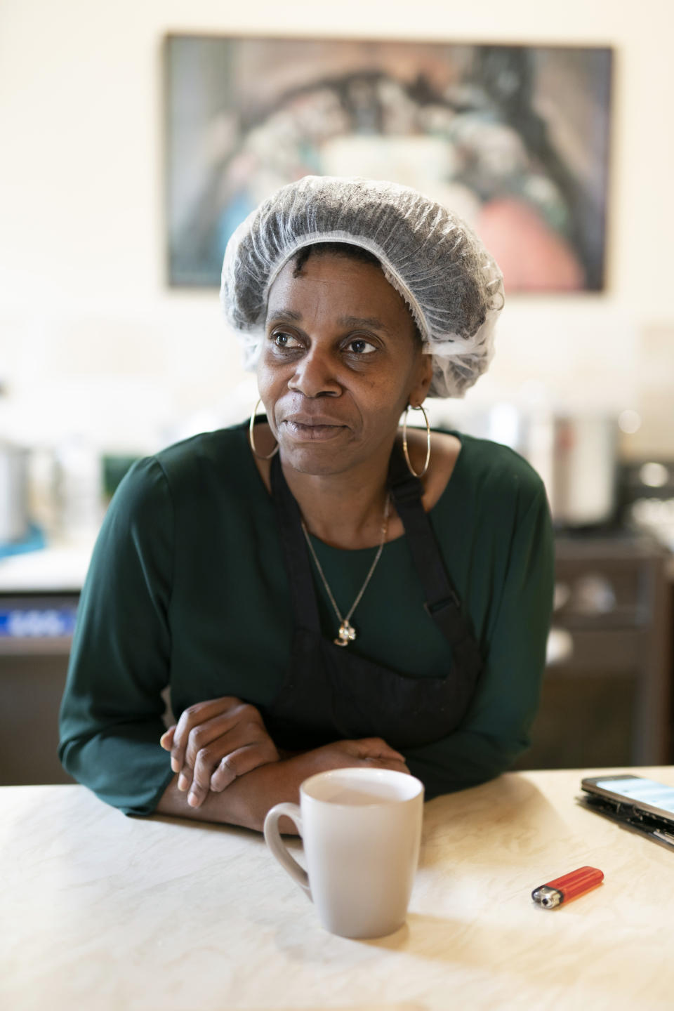 Chief coordinator Glenda Andrew poses for a photo as she prepares West Indian meals with members of the Preston Windrush Covid Response team, at the Xaverian Sanctuary, in Preston, England, Friday Feb. 19, 2021. Once a week they distribute meals to people in Preston and surrounding communities in northwestern England that have recorded some of the U.K.’s highest coronavirus infection rates. The meal program grew out of Andrew’s work with Preston Windrush Generation & Descendants, a group organized to fight for the rights of early immigrants from the Caribbean and other former British colonies who found themselves threatened with deportation in recent years. (AP Photo/Jon Super)