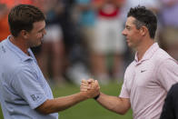 Keith Mitchell, left, congratulates Rory McIlroy on his win in the Wells Fargo Championship golf tournament at Quail Hollow on Sunday, May 9, 2021, in Charlotte, N.C. (AP Photo/Jacob Kupferman)