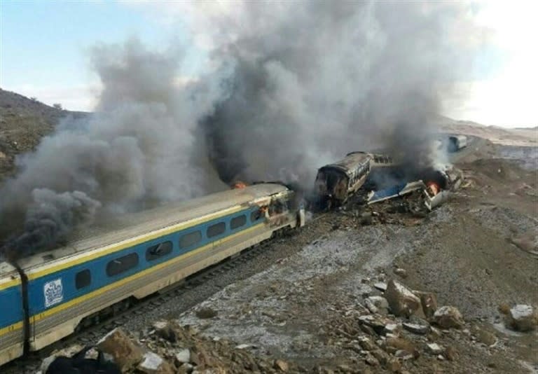 Smoke billows from destroyed train carriages following an accident in Semnan province, some 250 kms east of the Iranian capital Tehran, on November 25, 2016