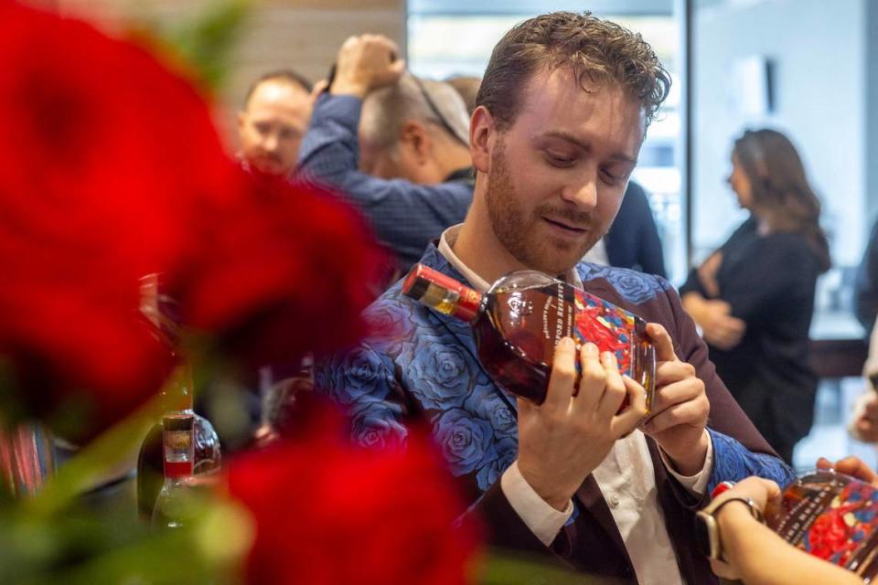 Wylie Caudill holds a bottle of Woodford Reserve’s commemorative 2024 Kentucky Derby bourbon, featuring his art work, during a press conference at Churchill Downs in Louisville, Ky., on Tuesday, March 5, 2024.