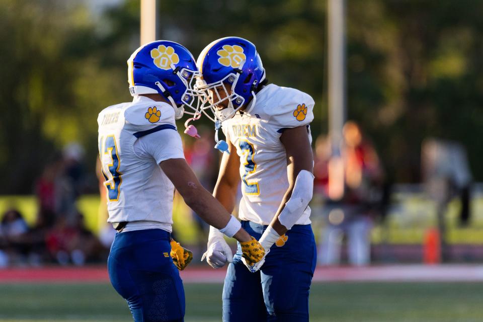 Orem’s Kaue&nbsp;Akana and Roger&nbsp;Saleapaga celebrate during their high school football season opener against East.