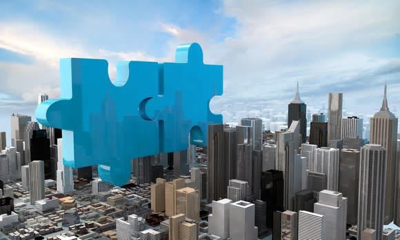 Two puzzle pieces representing a merger.